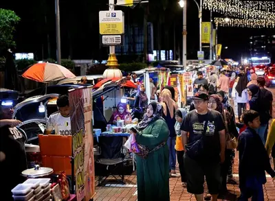 a crowd of people walking around a street market at IPOH City Centre ICC Suites by HWC in Ipoh