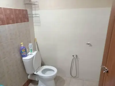 a bathroom with a white toilet and a shower at Santai Salai Homestay and Cafe in Kepala Batas