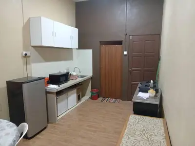 a small kitchen with a sink and a refrigerator at Santai Salai Homestay and Cafe in Kepala Batas