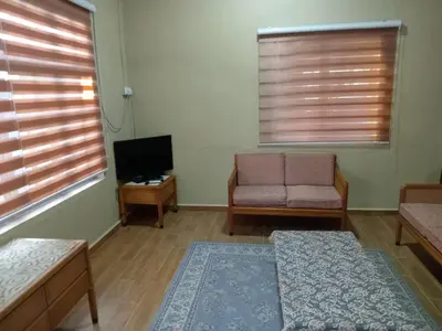 a living room with a couch and a tv at Santai Salai Homestay and Cafe in Kepala Batas