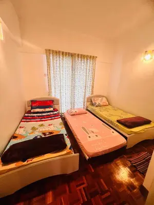 a room with two beds in it with a window at Rayyan'Homestay PARKVIEW in Tanah Rata