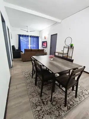 a dining room table and chairs in a living room at IRDINA HomestayMuslim's 2 at Emerald Avenue Brinchang Centrum in Brinchang