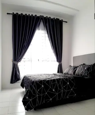 a bedroom with a bed and a large window at Zayyan Homestay Parit Buntar in Parit Buntar