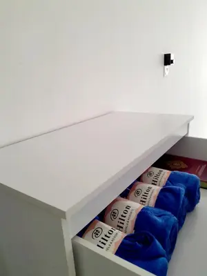 a white drawer with blue towels in it at Zayyan Homestay Parit Buntar in Parit Buntar