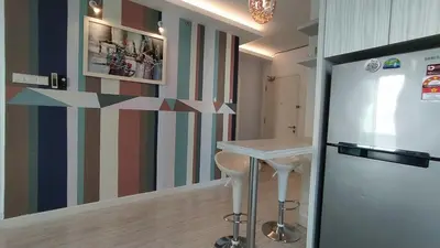 a kitchen with a refrigerator and a striped wall at Mansion One 279 in George Town