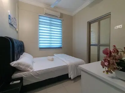 a small room with a bed and a window at Inap Kluster Height , Kuala Kangsar in Kuala Kangsar