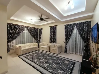 a living room with two couches and a ceiling fan at Inap Kluster Height , Kuala Kangsar in Kuala Kangsar