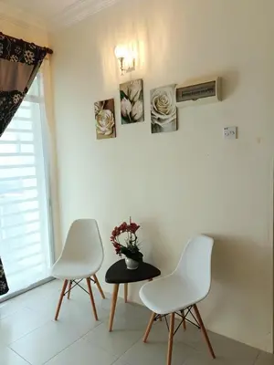 two white chairs and a table in a room at Inap Kluster Height , Kuala Kangsar in Kuala Kangsar