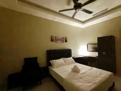 a bedroom with a bed with a ceiling fan at Inap Kluster Height , Kuala Kangsar in Kuala Kangsar