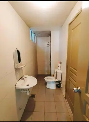 a small bathroom with a toilet and a sink at Ummus Homestay in Tanah Rata