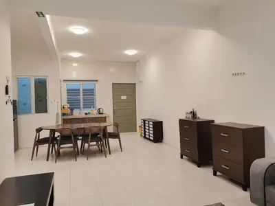 a kitchen and dining room with a table and chairs at Ummus Homestay in Tanah Rata