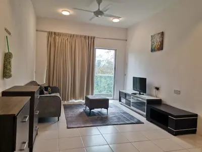 a living room with a couch and a tv and a chair at Ummus Homestay in Tanah Rata
