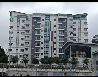 a large white building with trees in front of it at Ummus Homestay in Tanah Rata