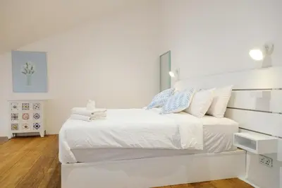 a white bedroom with a large white bed with pillows at Tung Kidcove Centrum Cameron in Brinchang