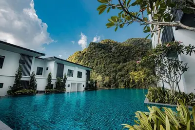 a swimming pool in a resort with mountains in the background at ThemeParkview-Sunway Onsen-2br2b in Ipoh