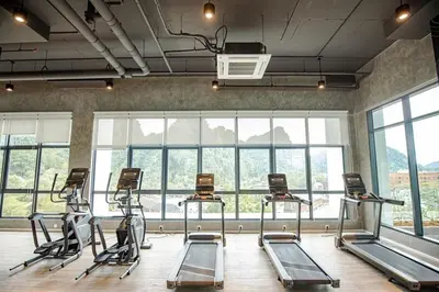 a gym with several exercise bikes in a room with windows at ThemeParkview-Sunway Onsen-2br2b in Ipoh