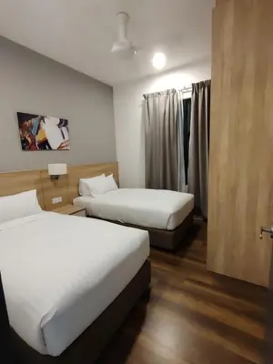 a hotel room with two beds and a window at ThemeParkview-Sunway Onsen-2br2b in Ipoh