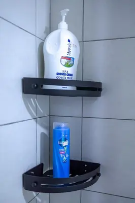 a bottle of mouthwash and a cup on a shelf at The Sun #3BR #11 FamilyStay #BayanLepas in Bayan Lepas