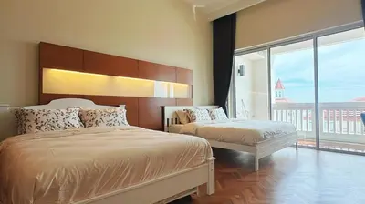 a bedroom with two beds and a large window at Straits Quay Highest & Spacious Seaview Suite - 3 in Bagan Jermal