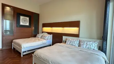 a bedroom with two beds and a headboard at Straits Quay Highest & Spacious Seaview Suite - 3 in Bagan Jermal