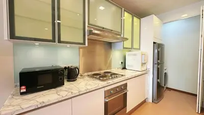 a kitchen with a microwave and a stove top oven at Straits Quay Highest & Spacious Seaview Suite - 3 in Bagan Jermal
