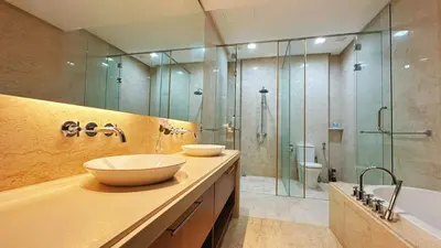 a bathroom with two sinks and a shower at Straits Quay Highest & Spacious Seaview Suite - 3 in Bagan Jermal