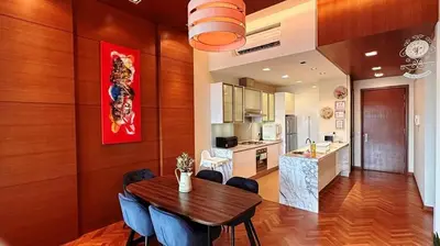 a kitchen and dining room with a wooden table and chairs at Straits Quay Highest & Spacious Seaview Suite - 3 in Bagan Jermal
