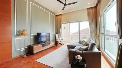 a living room with a couch and a flat screen tv at Straits Quay Highest & Spacious Seaview Suite - 3 in Bagan Jermal