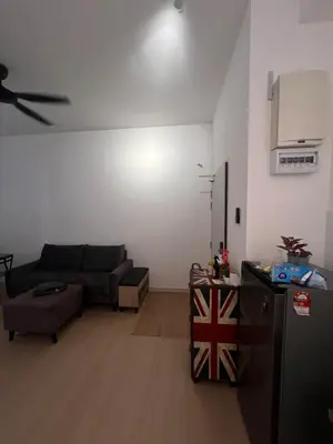 a living room with a couch and a kitchen at horizon ipoh in Ipoh