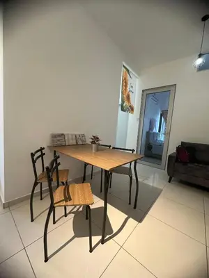 a dining table and chairs in a living room at horizon ipoh in Ipoh