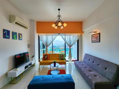 a living room with a couch and a large window at Ipoh Kinta Riverfront Air-Con Cozy Home in Ipoh