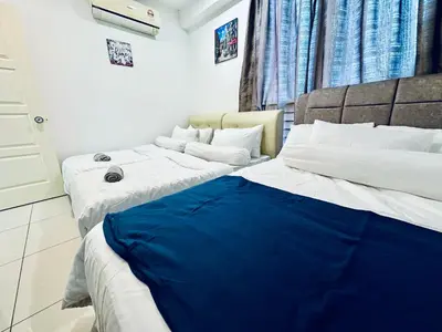two beds sitting next to each other in a room at 8pax 2-Bedroom l Seaview l Georgetown l Gleneagles l Mansion One in George Town