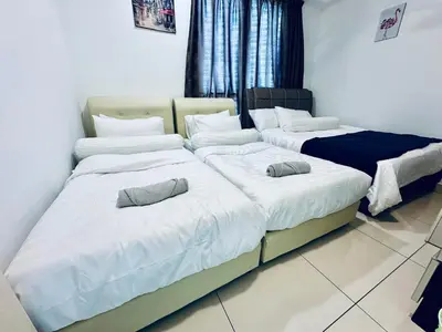 two beds in a room with white sheets and pillows at 8pax 2-Bedroom l Seaview l Georgetown l Gleneagles l Mansion One in George Town