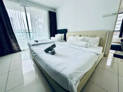 a large bed with a teddy bear sitting on it at 8pax 2-Bedroom l Seaview l Georgetown l Gleneagles l Mansion One in George Town