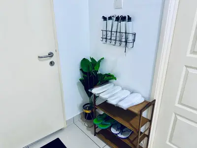 a bathroom with a rack of towels and a door at 8pax 2-Bedroom l Seaview l Georgetown l Gleneagles l Mansion One in George Town