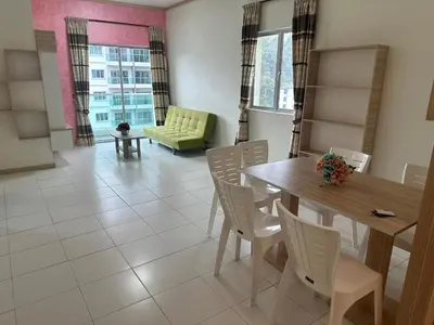 a dining room with a table and chairs and a couch at Family Stay at Quintet A3A-3A-6 in Tanah Rata