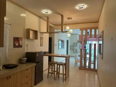 a kitchen with a counter and a dining room at Family Stay at Quintet A3A-3A-6 in Tanah Rata