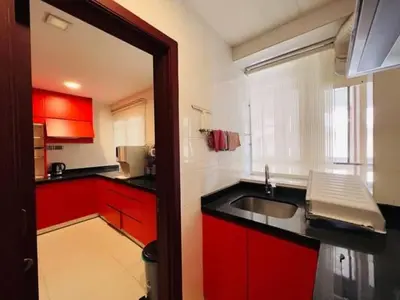 a kitchen with red cabinets and a sink at Shamplex Rentals in Kampar