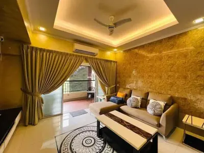 a living room with a couch and a table at Shamplex Rentals in Kampar