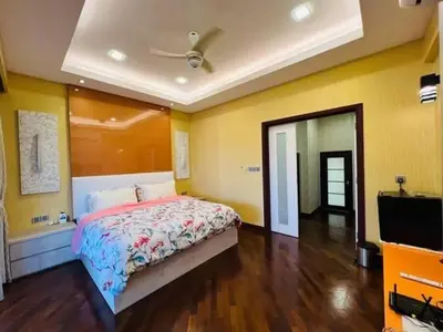 a bedroom with a bed and a flat screen tv at Shamplex Rentals in Kampar