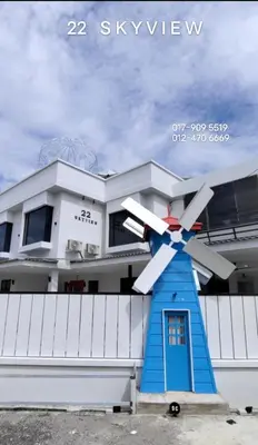 a house with a windmill in front of it at 22 Skyview in Bukit Mertajam