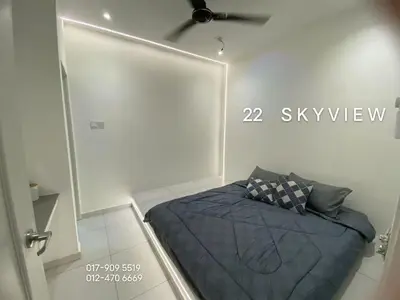 a bedroom with a blue bed in a room at 22 Skyview in Bukit Mertajam