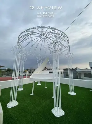 a white bench on top of green grass at 22 Skyview in Bukit Mertajam