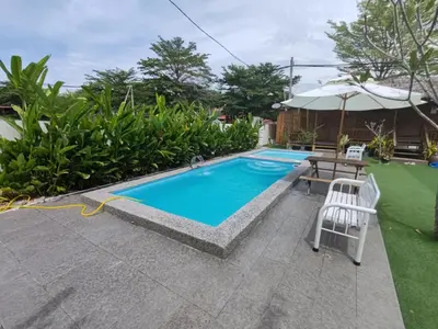 a pool with a table and chairs next to a house at Aeden Villa Roomstay & Homestay in Kuala Kangsar