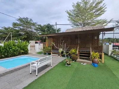 a villa with a pool and a house at Aeden Villa Roomstay & Homestay in Kuala Kangsar