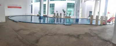 a swimming pool in the middle of a building at 3 Bedroom Apartment YuCasa Sg Nibong Penang in Bayan Lepas