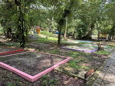a park with pink tables in the grass at Camp Site in Tapah