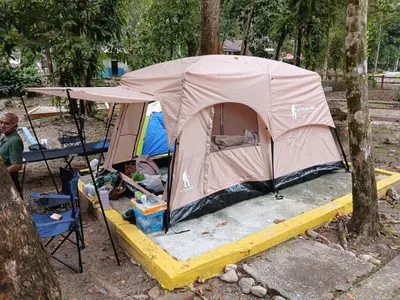 a tent is set up in the woods at Camp Site in Tapah