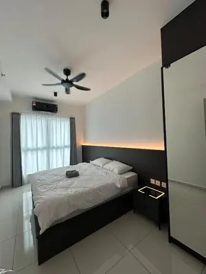 a bedroom with a bed with a ceiling fan at ICC Premier Suites Ipoh City Centre by Landmark in Ipoh