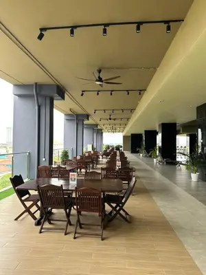 a cafeteria with wooden tables and chairs in a building at ICC Premier Suites Ipoh City Centre by Landmark in Ipoh